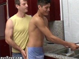 A young Asian twink gives blow job to a hot daddy
