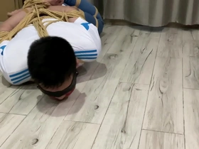 Gay bondage play with an Asian boy in a hogtie