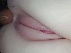 A young Japanese girl enjoys an anal toy insertion