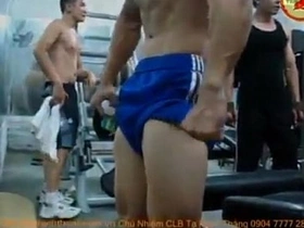 Asian hunk flaunts his muscles and flexes in the gym.