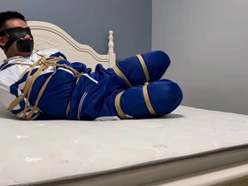 Asian boy in hogtie bondage with ropes and shackles in a homemade video
