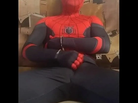 Gay Spidey in tight suit masturbates.