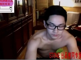 Muscular Chinese cam boy in socks shows off his big cock.