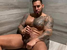 A steamy shower scene with a tattooed, pierced, and gay porn star.