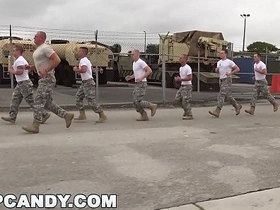 Muscular men in uniform engage in a steamy Glory Hole session.